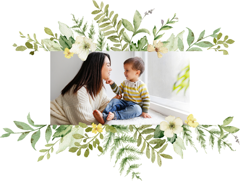 Photo of mom with toddler bordered by plants