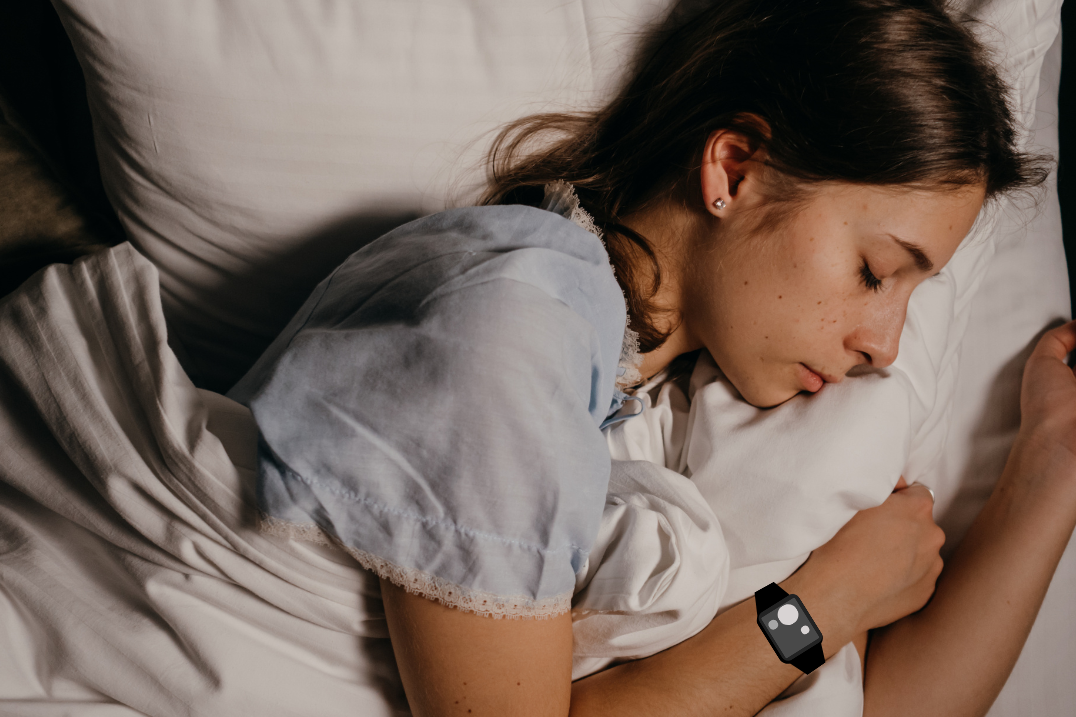 Woman sleeping with actigraphy watch